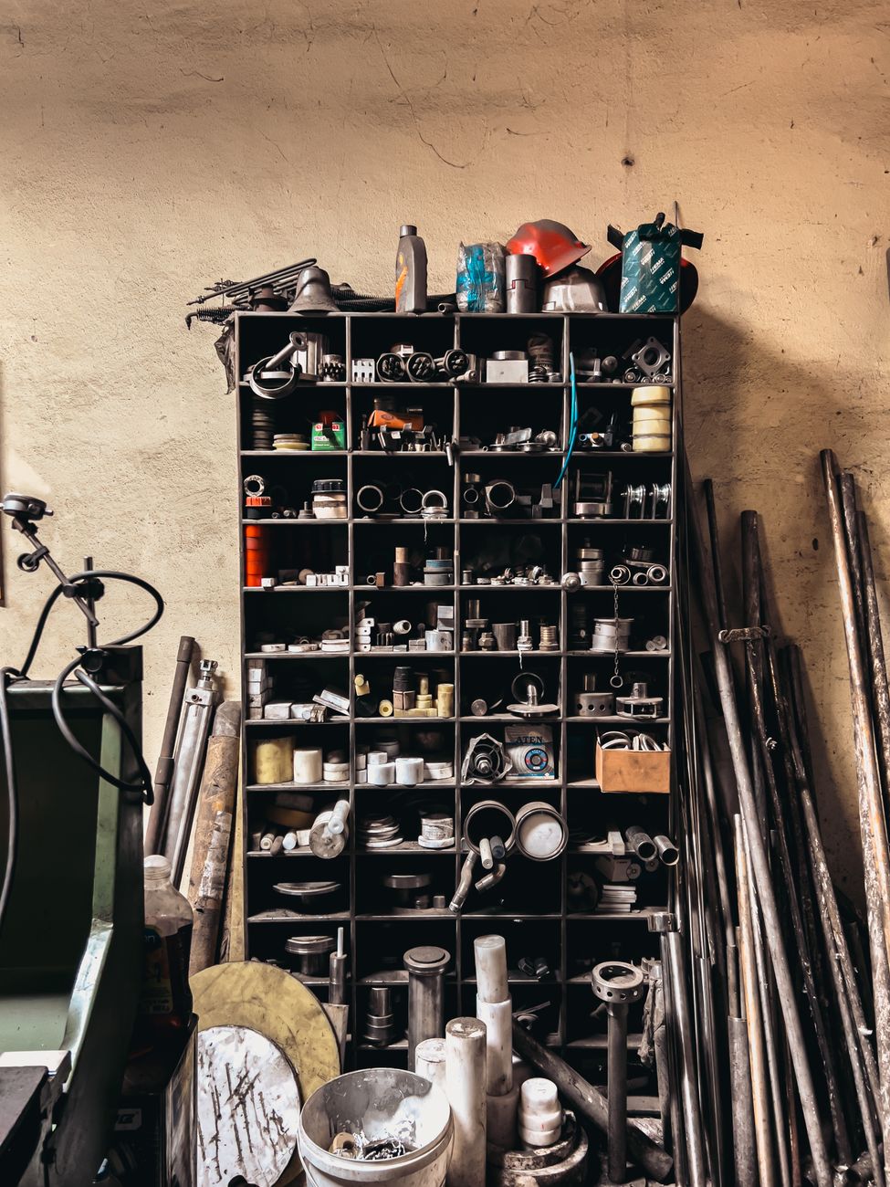 Racked pipe lengths and shelves of fittings in a plumber's workshop